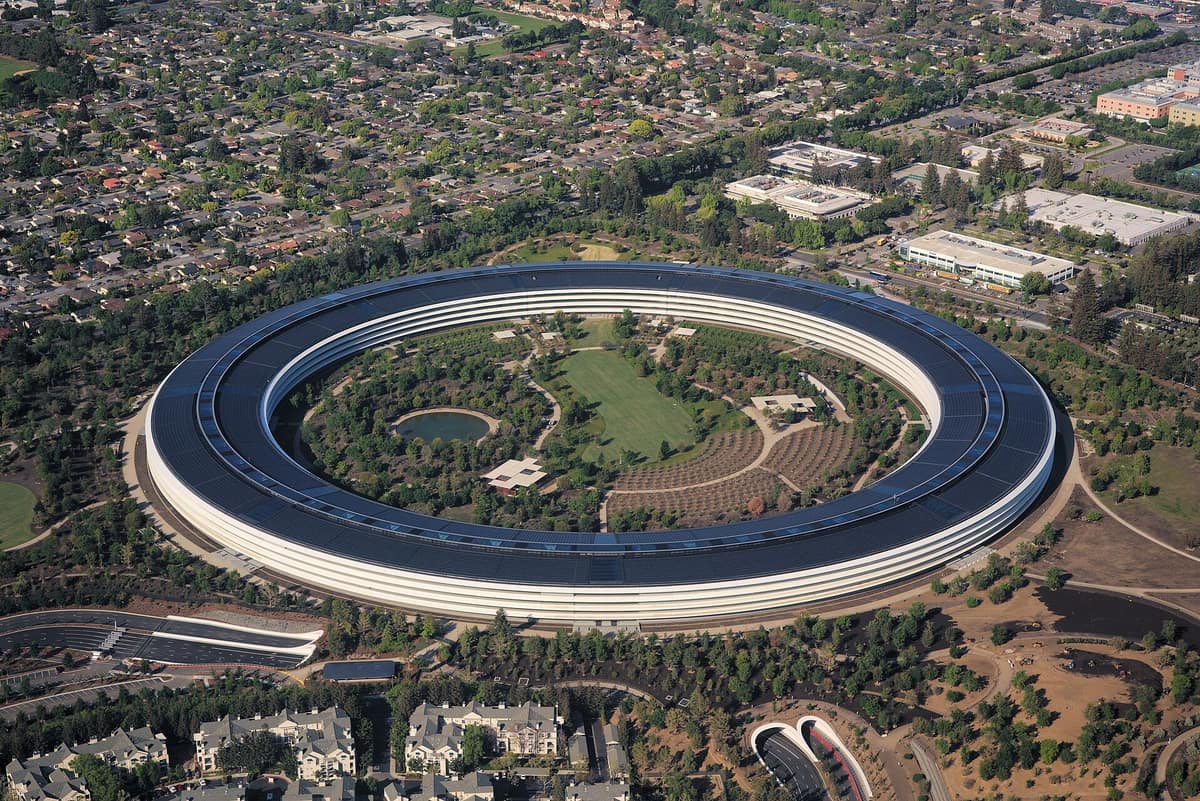 Aerial photograph of Apple Park, Apple's ring-shaped headquarters in Cupertino, California, with its solar-paneled roof.
