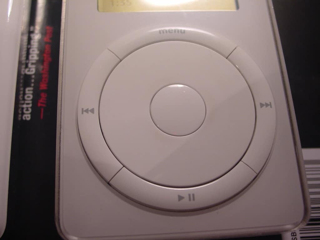 Original first-generation Apple iPod showing its monochrome LCD and mechanical scroll wheel.